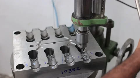 Closeup of the machine CNC processing machining drilling a metal surface in the Stock Footage 239452768
