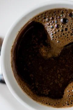 Closeup macro above cup of coffee with shallow depth of field Stock Photos