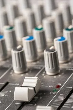 Closeup macro audio mixing console knobs and sliders. Stock Photos