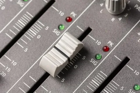 Closeup macro audio mixing console knobs and sliders. Stock Photos