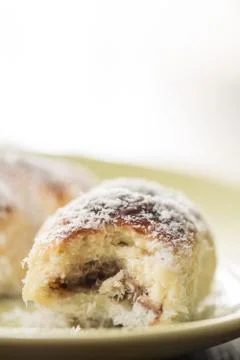 Closeup macro baked rolls with coconut served on the plate Foto stock