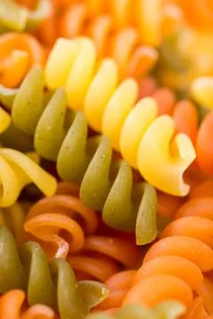 Closeup macro colored macaroni background Stock Photos
