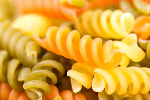 Closeup macro colored macaroni background Stock Photos