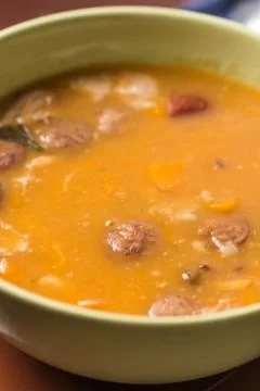 Closeup macro of cooked beans with sausages in the bowl Stock Photos
