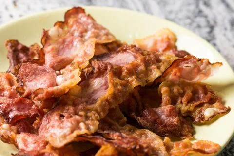 Closeup macro of crisp fried bacon on the plate Stock Photos