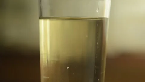 Closeup macro drink water bubbles are going up in the glass Stock Footage 138222187