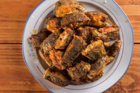 Closeup macro flat lay above served fried hake on the plate Stock Photos