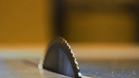Closeup macro frame saw blades on a blurred yellow background Stock Footage 129445716