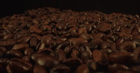 Closeup macro a group roasted brown or black coffee grains background - motion Stock Footage 243220279