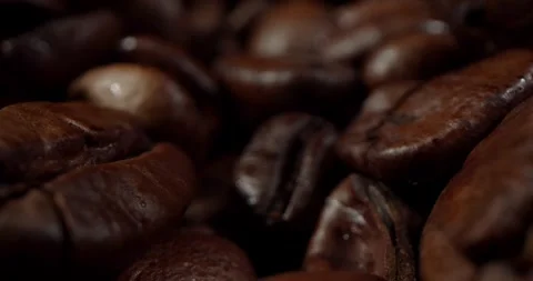 Closeup macro a group roasted brown or black coffee grains background - motion 動画素材 243220397