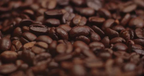 Closeup macro a group roasted brown or black coffee grains background - motion Vidéo 243220759