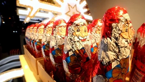 Closeup macro of happy red chocolate Santa Claus on the showcase with bright Video stock 120161799