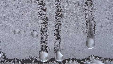Closeup macro of ice crystals on window melting, time lapse Stock Footage