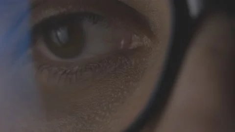 Closeup macro man's eye focused on the screen, working, reading, surfing Stock Footage 164059340