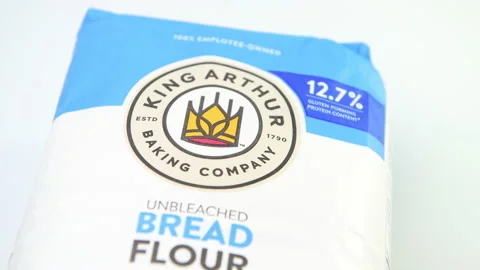 Closeup macro panning of King Arthur unbleached bread flour on white background Stock Footage 179070161