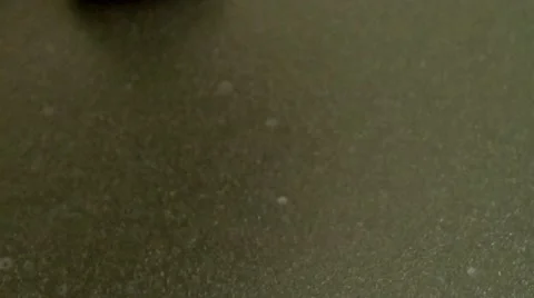 Closeup macro panning shot over blueberry pancake batter as it pours onto coo Stock Footage 63108467