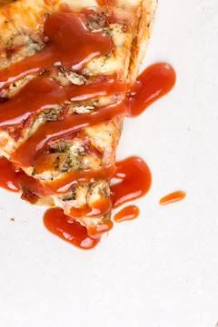 Closeup macro of pizza slice with ham mushrooms and ketchup on the white marb Stock Photos