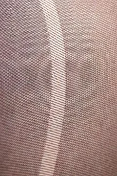 A closeup macro portrait of the texture of a rip, tear, run, ladder in the fa 写真素材