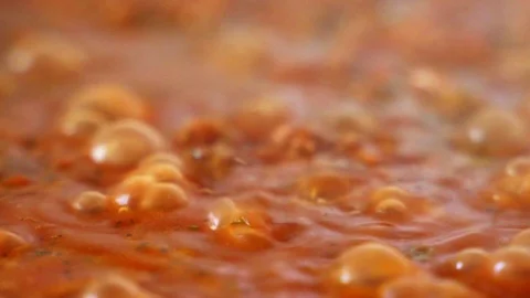 Closeup macro of rich red tomato vegetable sauce boiling in saucepan in the Stock Footage 126549748