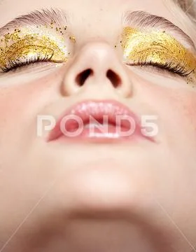 Closeup macro shot of closed human female face with yellow smoky eyes beauty Stock Photos