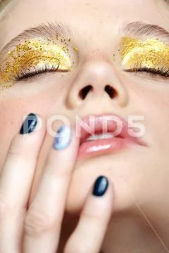 Closeup macro shot of closed human female face with yellow smoky eyes beauty Stock Photos