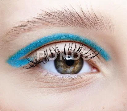 Closeup macro shot of human female eye and with blue smoky eyes shadows Stock Photos