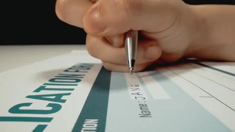 Closeup macro shot movement of hand filling data on job application form. Stock Footage 244469597