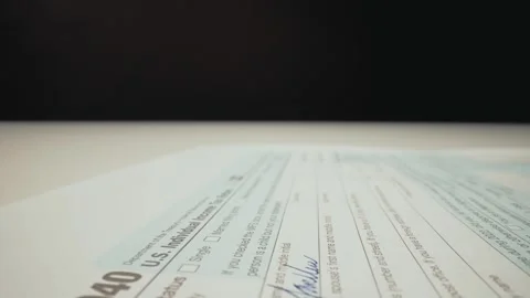 Closeup macro shot movement shot of corporate accountant lling 1040 tax form. Stock Footage 241006268