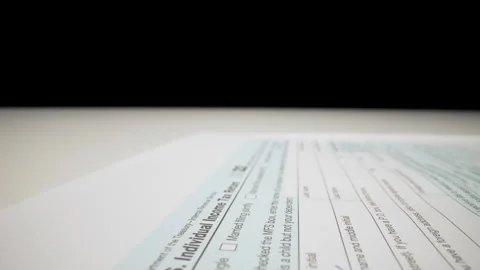 Closeup macro shot movement shot of corporate accountant lling 1040 tax form. Stock Footage 251846976
