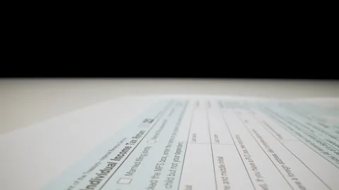 Closeup macro shot movement shot of corporate accountant lling 1040 tax form. Stock Footage 252845618