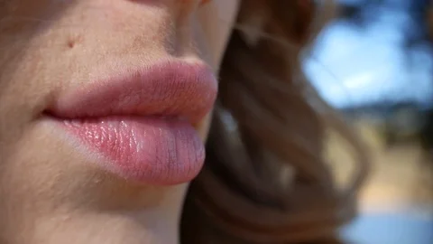 Closeup macro shot sexy lips of beautiful young woman outdoors Stock Footage 123254287
