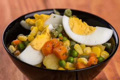 Closeup macro vegetable salad with corn eggs potatoes carrot Stock Photos