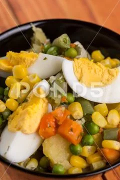 Closeup macro vegetable salad with corn eggs potatoes carrot Stock Photos