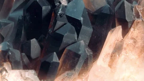 Closeup macro video of crystal shards of smoky quartz slowly rotating Stock Footage 247396127
