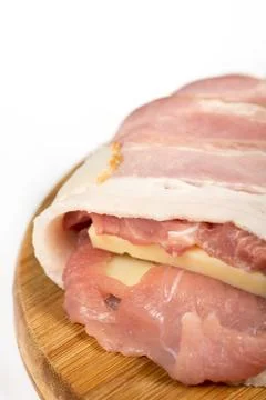 Closeup macro view of raw meat stuffed with yellow cheese and ro Stock Photos