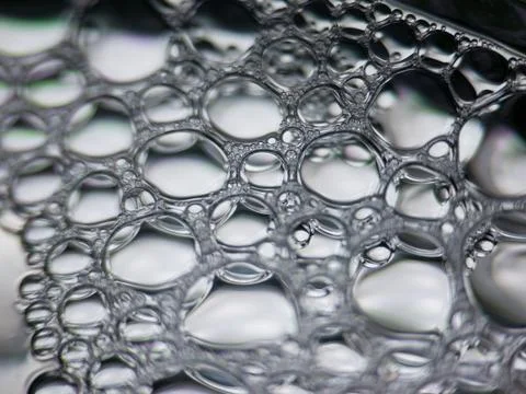 Closeup macro view of soap bubbles forming abstract pattern Stock Photos