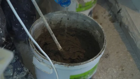 Closeup of making mortar in bucket at construction site Stock Footage 103283456