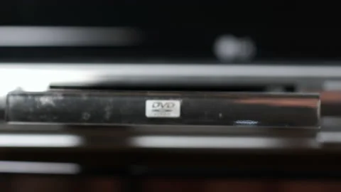 Closeup of Male Hand Inserts DVD Disk into Player Stock Footage 151590711