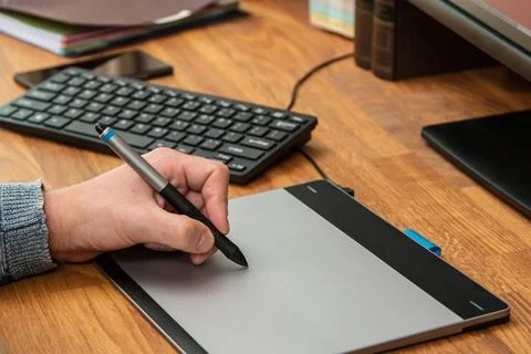 Closeup of male hands during using a graphic tablet 写真素材
