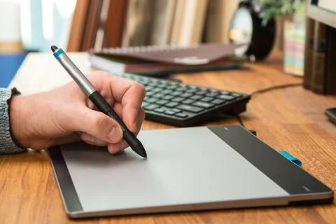 Closeup of male hands during using a graphic tablet Stock Photos