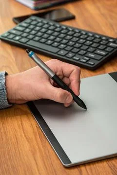 Closeup of male hands during using a graphic tablet Stock Photos