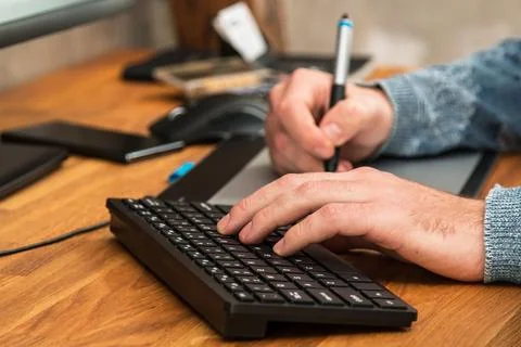 Closeup of male hands during using a graphic tablet 写真素材