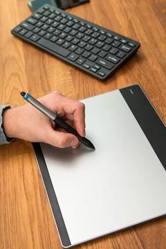 Closeup of male hands during using a graphic tablet Stock Photos