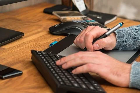 Closeup of male hands during using a graphic tablet Stock Photos