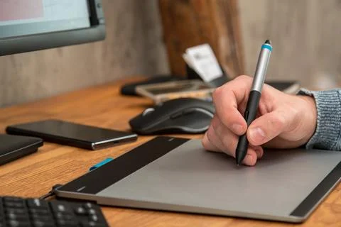 Closeup of male hands during using a graphic tablet 写真素材