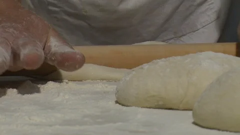 Closeup of male hands of professional cooker working with fresh dough. Real time 動画素材 90719341