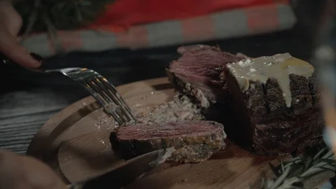Closeup of male hands using knife and fork while cutting first bite from Stock Footage 99586029