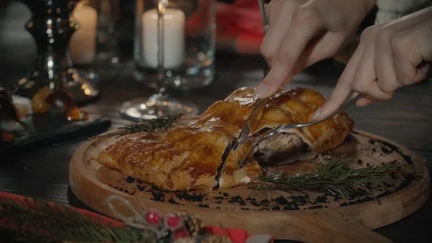 Closeup of male hands using knife and fork while cutting first bite from Stock Footage 99586142