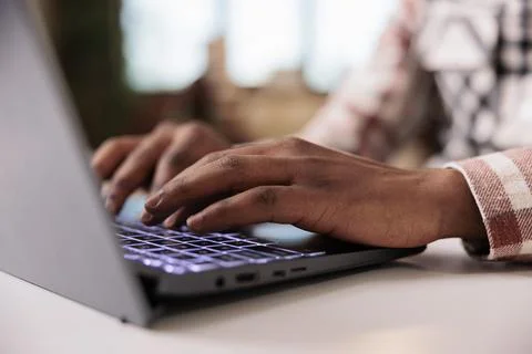 Closeup of male programmer writing code on laptop keyboard while working remote 库存照片