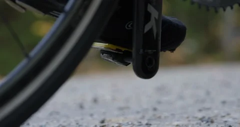 Closeup of male road cyclist clipping in and getting ready for a long bike ride Stock Footage